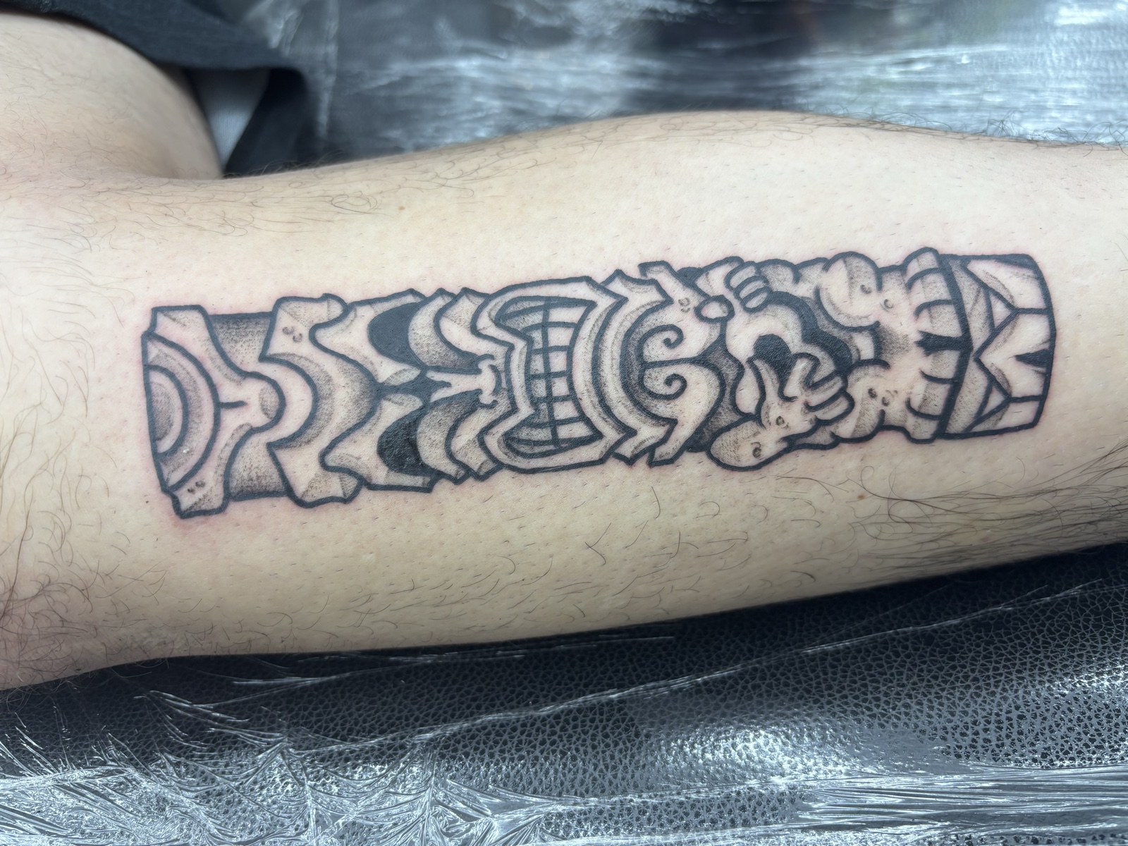 Polynesian / blackwork arm band — pattern-driven cultural piece with negative space discipline